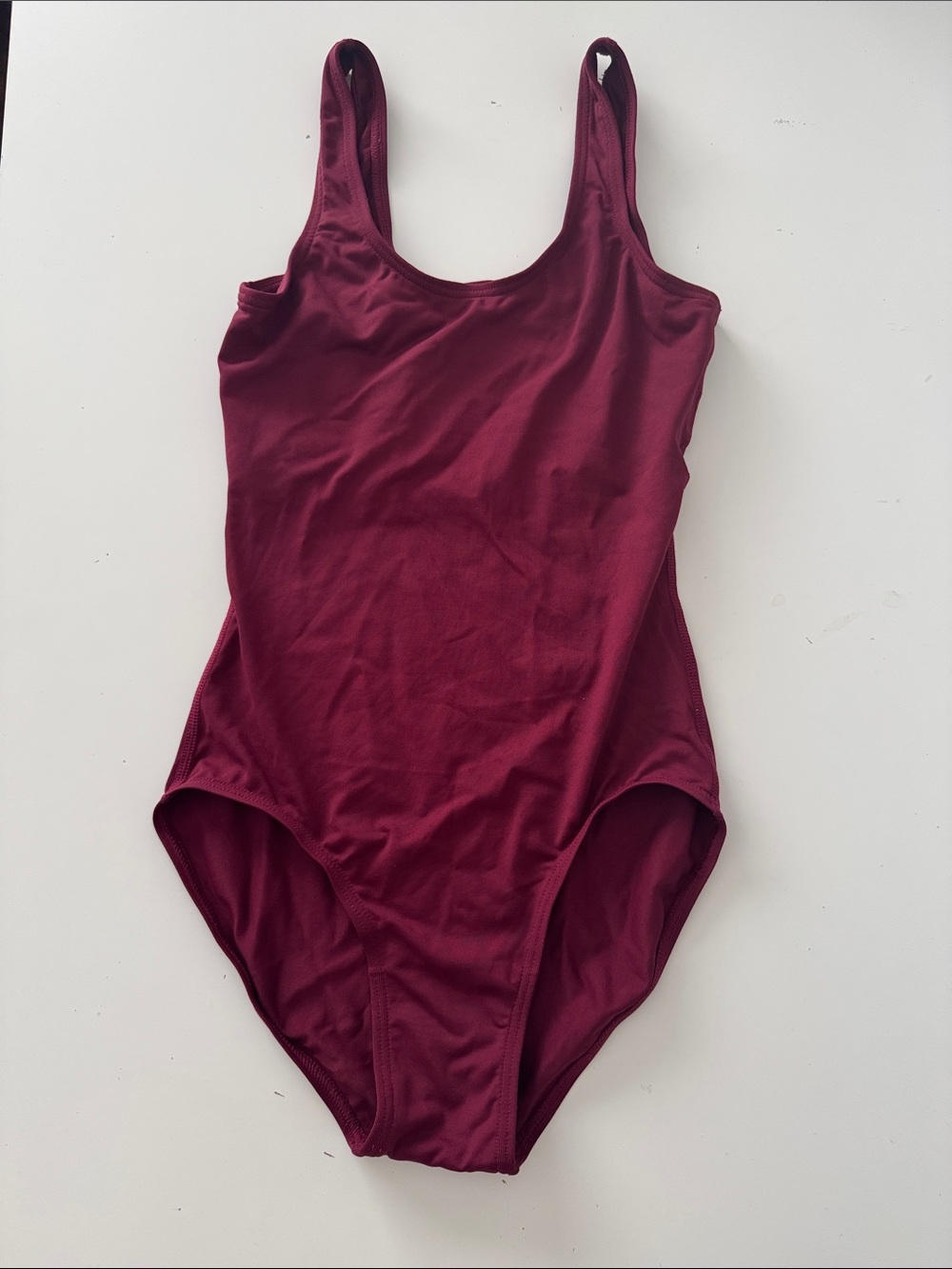Solid Burgundy leotard with lining and shelfbra support. Size XS